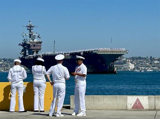 Sailors in Coronado watch the USS Lincoln arrive back home