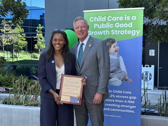 Rep. Peters stands with a childcare provider who was recognized in the community
