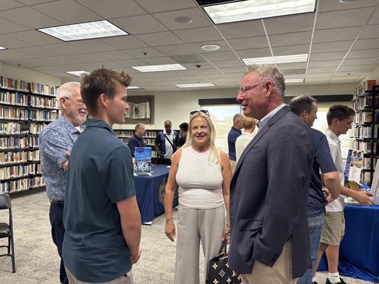 Rep. Peters speaks with a family at the service academy information night