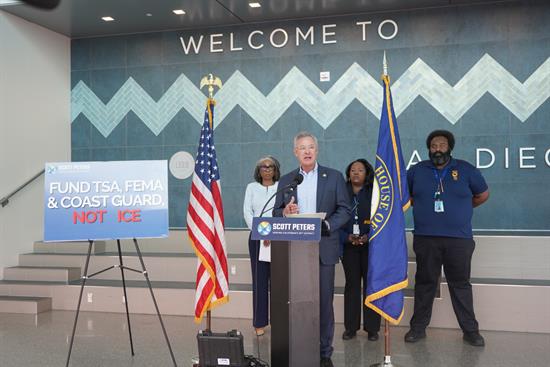Rep. Peters speaks at a podium at a press conference on DHS funding
