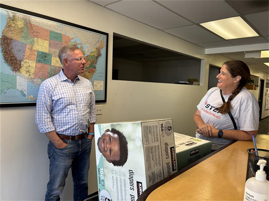 Rep. Peters speaks with STEP team members after donating diapers for their diaper distribution event