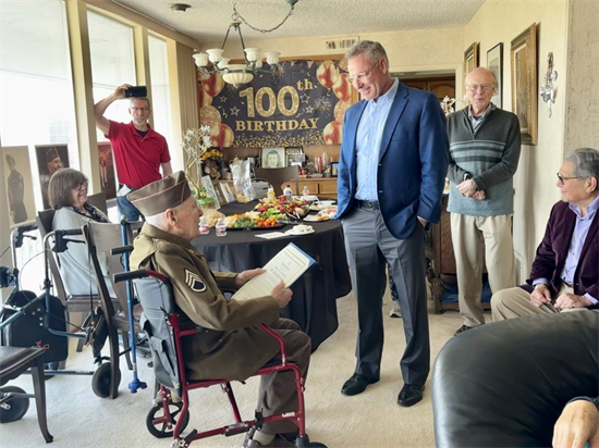 Rep. Peters speaks with a 100 year old veteran at his home