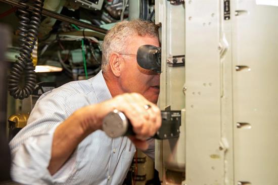 Rep. Peters looks through a periscope on the USS Springfield