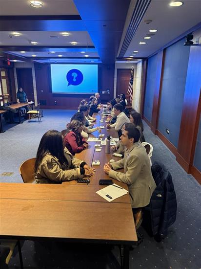 Rep. Peters' current staff gather around a table to play a speed bonding game
