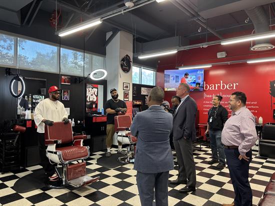 Rep. Peters speaks with barbors at City College's basic needs center